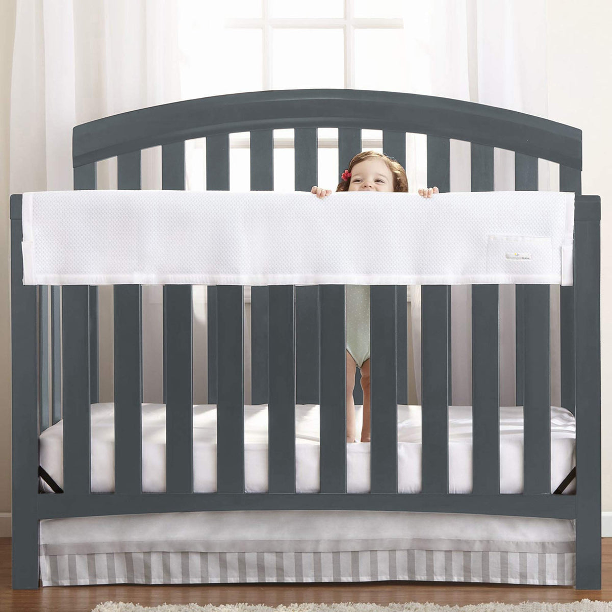 BreathableBaby railguard long panel cover on crib rail for teething protection.