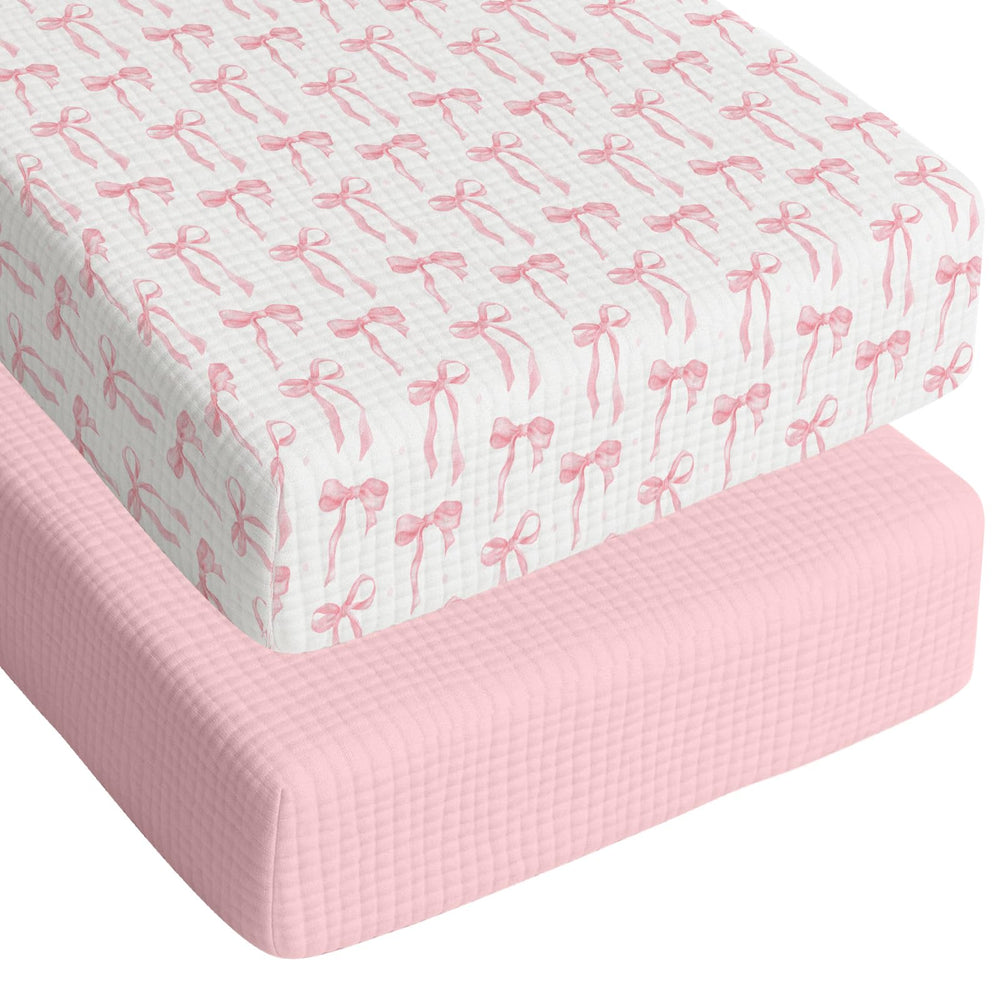 Breling pink bow crib sheet close-up showing soft cotton texture for baby comfort