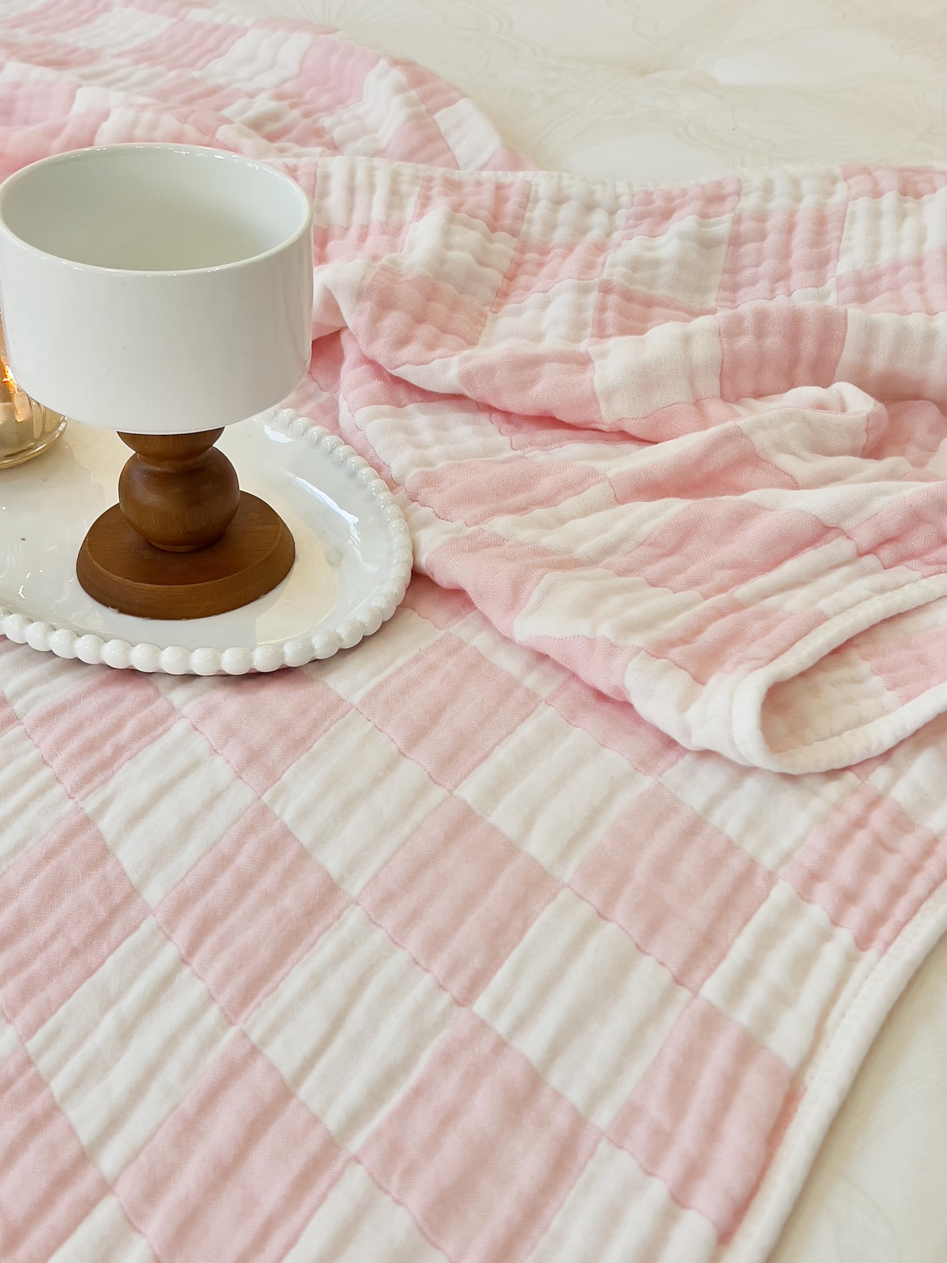 Brnabiou pink check blanket captured alongside newborn essentials.