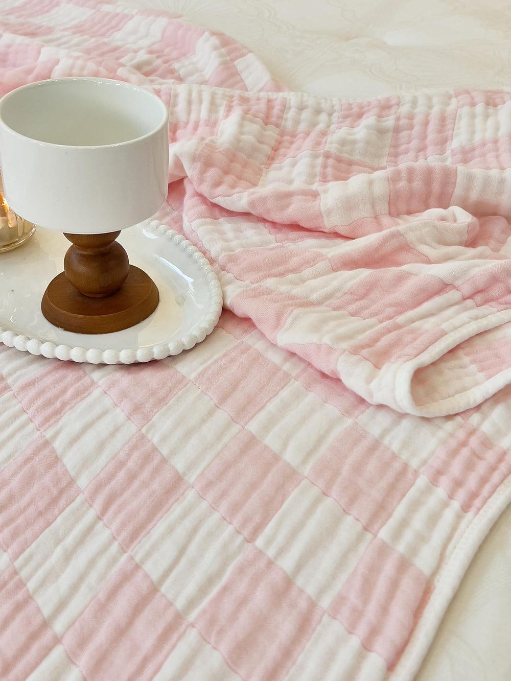 Brnabiou pink check blanket captured alongside newborn essentials.