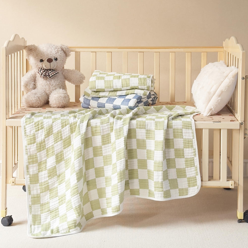 Brnabiou blanket swaddled around baby in sage green checker for secure sleep