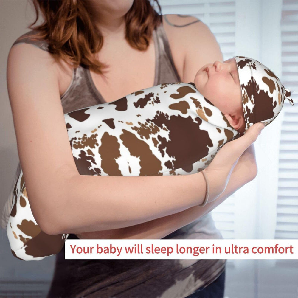 Broiteid cow-print newborn swaddle set doubles as a photography prop.