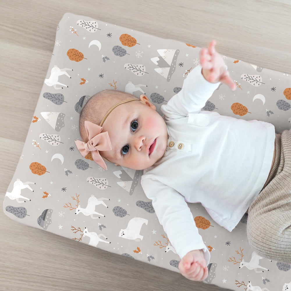 BROLEX changing pad cover Snowy Forest on changing table demonstrates secure, non-slip fit.