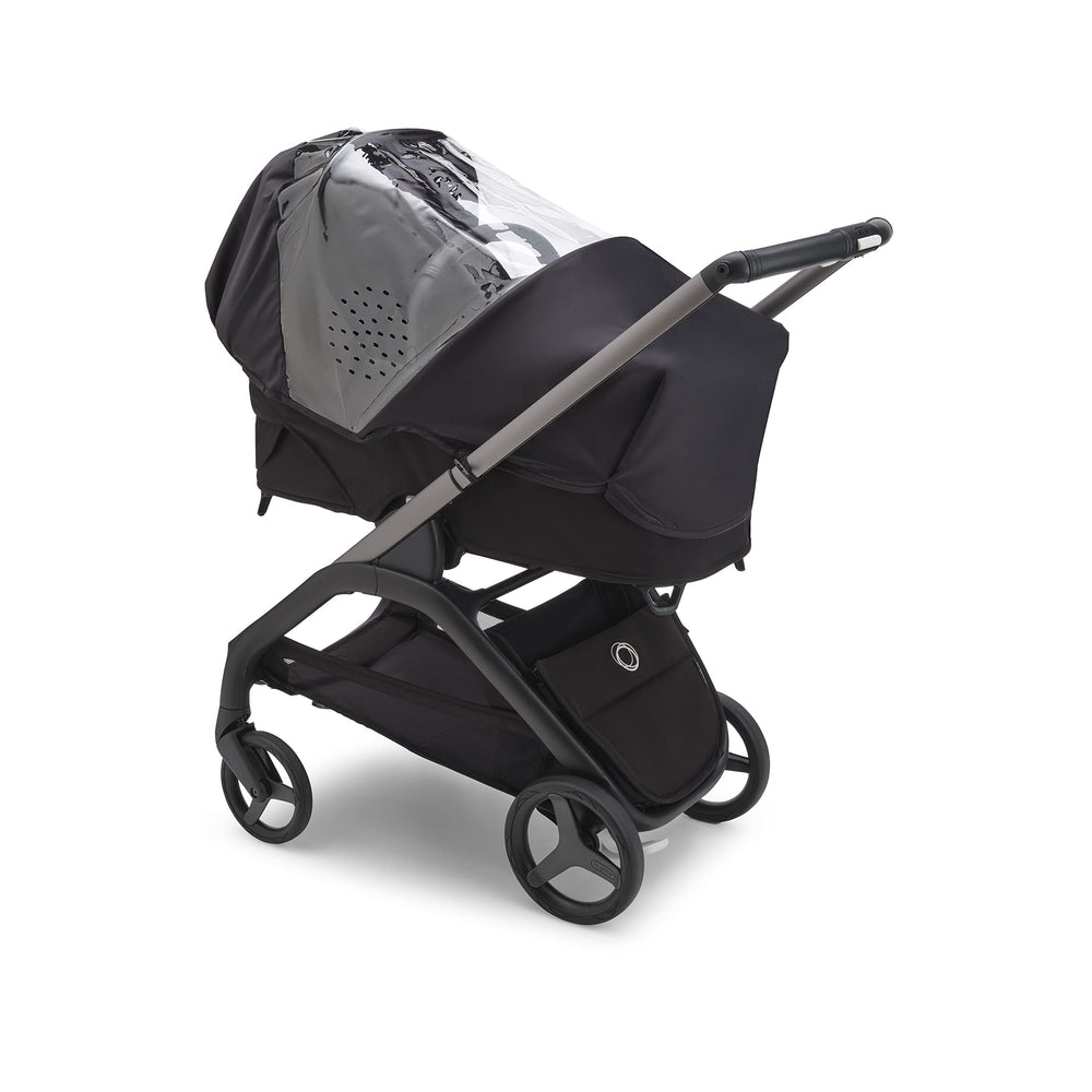 Bugaboo Dragonfly rain cover folded for compact storage in underseat basket.