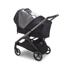 Bugaboo Dragonfly rain cover folded for compact storage in underseat basket.