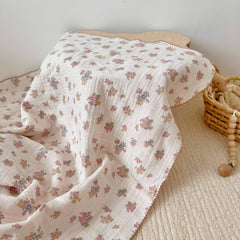 BuLuTu Muslin Cotton Baby Blanket draped over crib demonstrates generous size for growing babies.