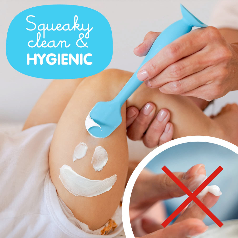 Bumco soft silicone spatula gliding smoothly on baby's skin