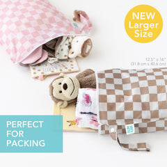 Bumkins Larger Wet Bag beige check with snap handle attached to a stroller for on-the-go use.