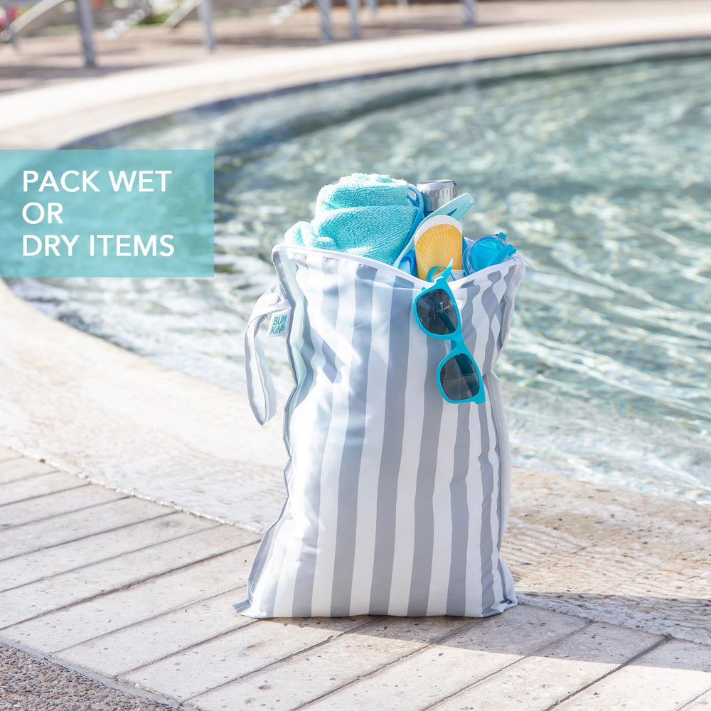 Bumkins wet bag snap handle attached to stroller for easy access