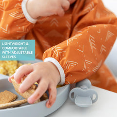 Bumkins Sleeved Bib elastic cuffs adapt as your child grows.