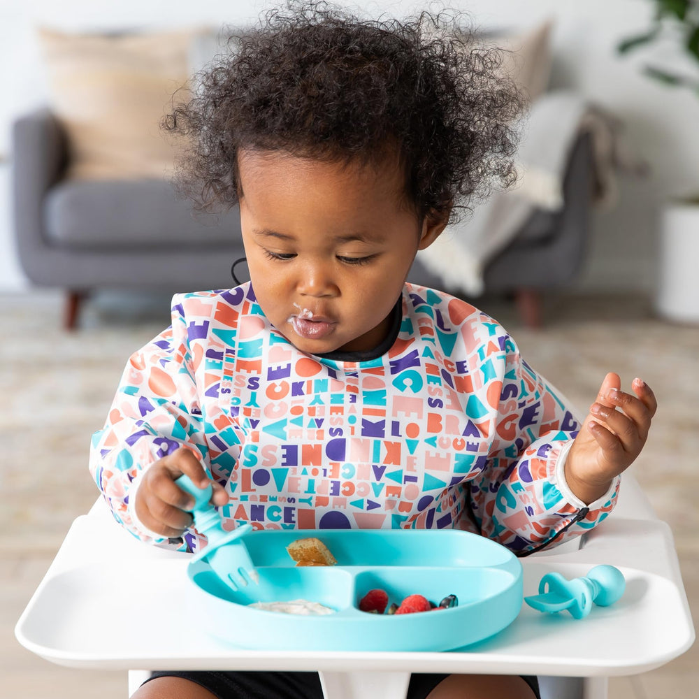 Bumkins Sleeved Bib waterproof fabric protects outfits from dribbles and splashes.