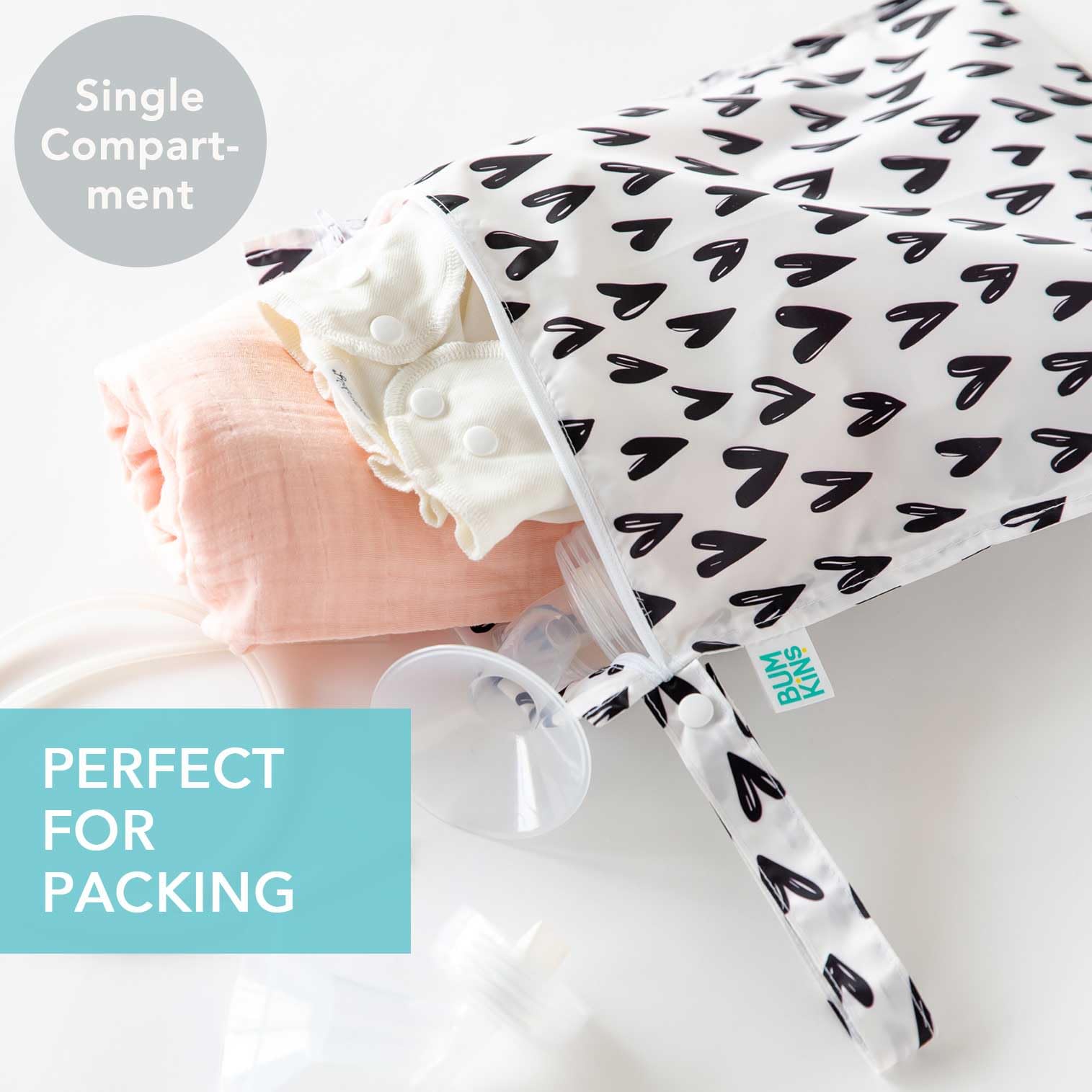 Bumkins waterproof wet bag arrows-hearts attached to stroller demonstrates quick-access storage
