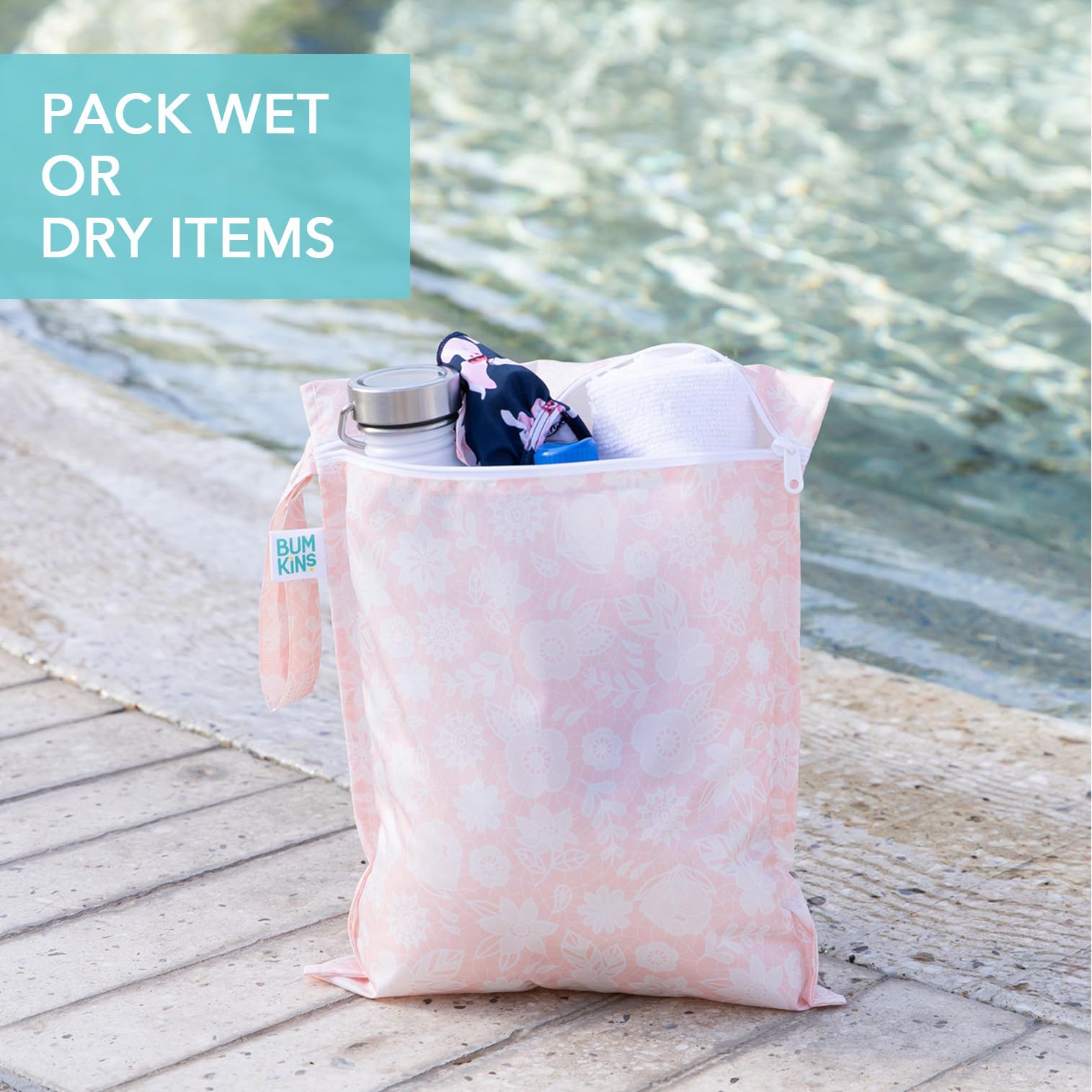 Bumkins Waterproof Wet Bag Floral Lace stores damp swimsuits after a beach day.