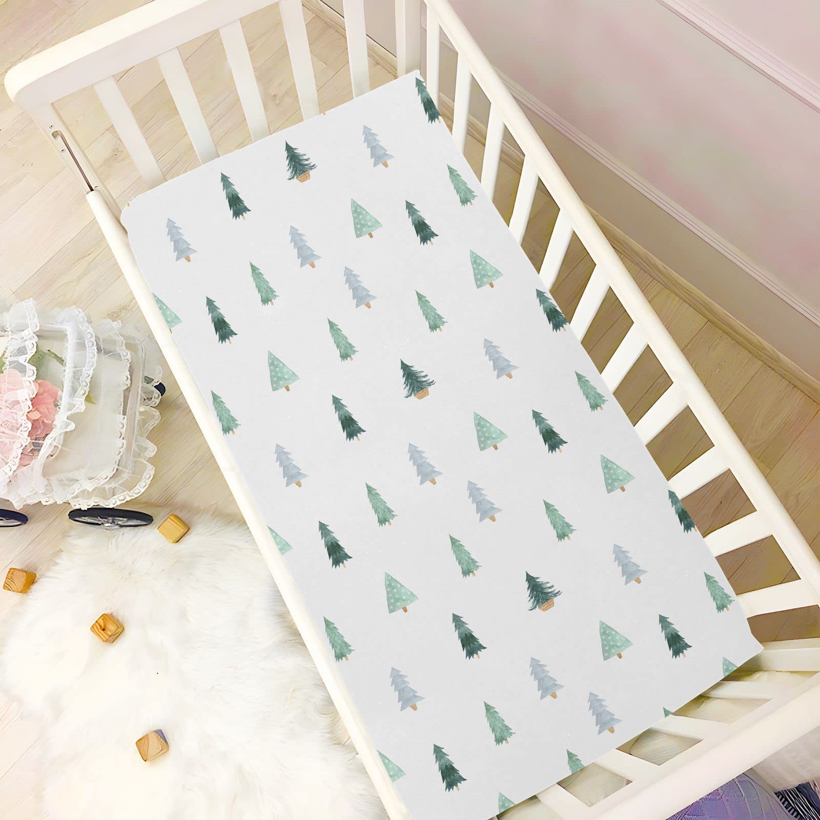 Burbuja Christmas Tree crib sheet fabric closeup highlights breathable cotton-like feel