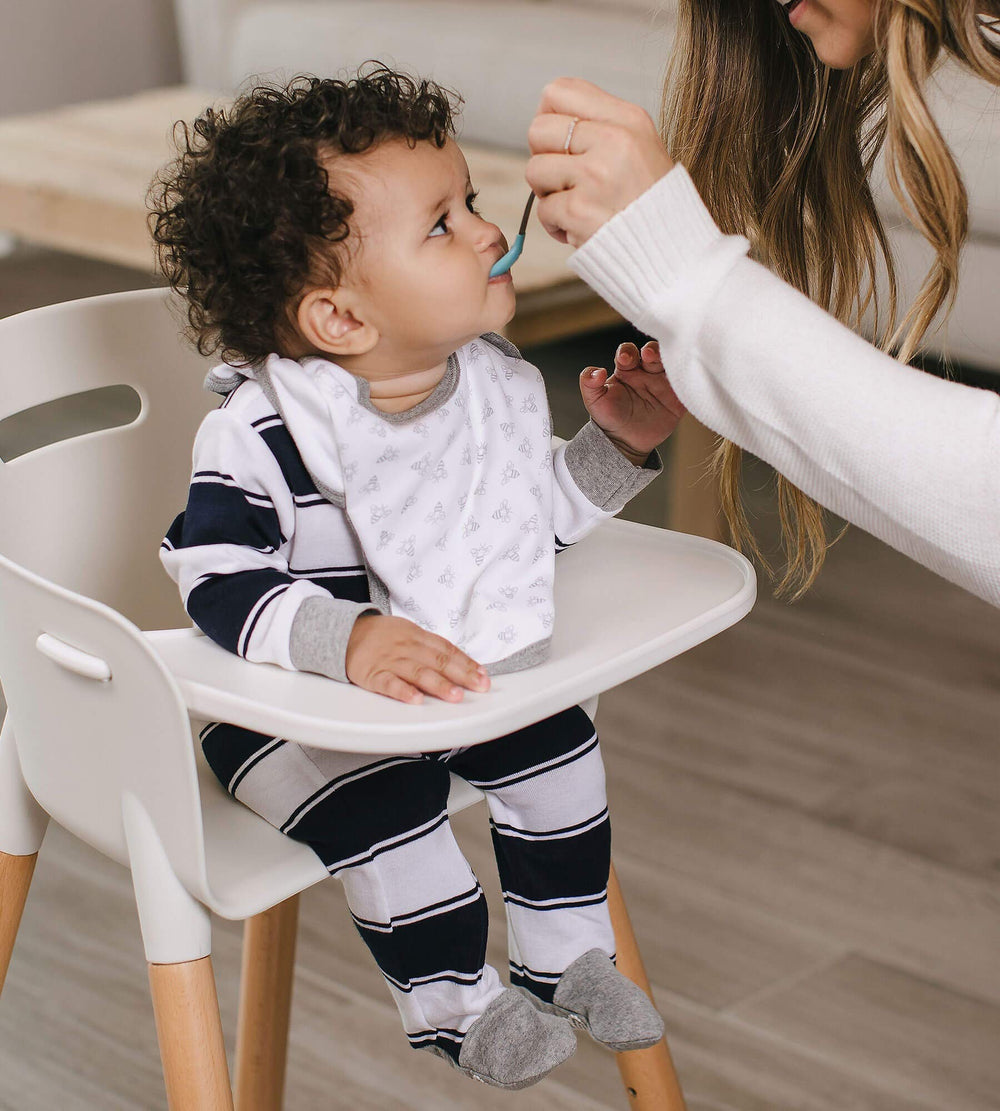 Burt's Bees Baby Bibs lap-shoulder fit demonstrates easy-on, easy-off for fuss-free dressing.