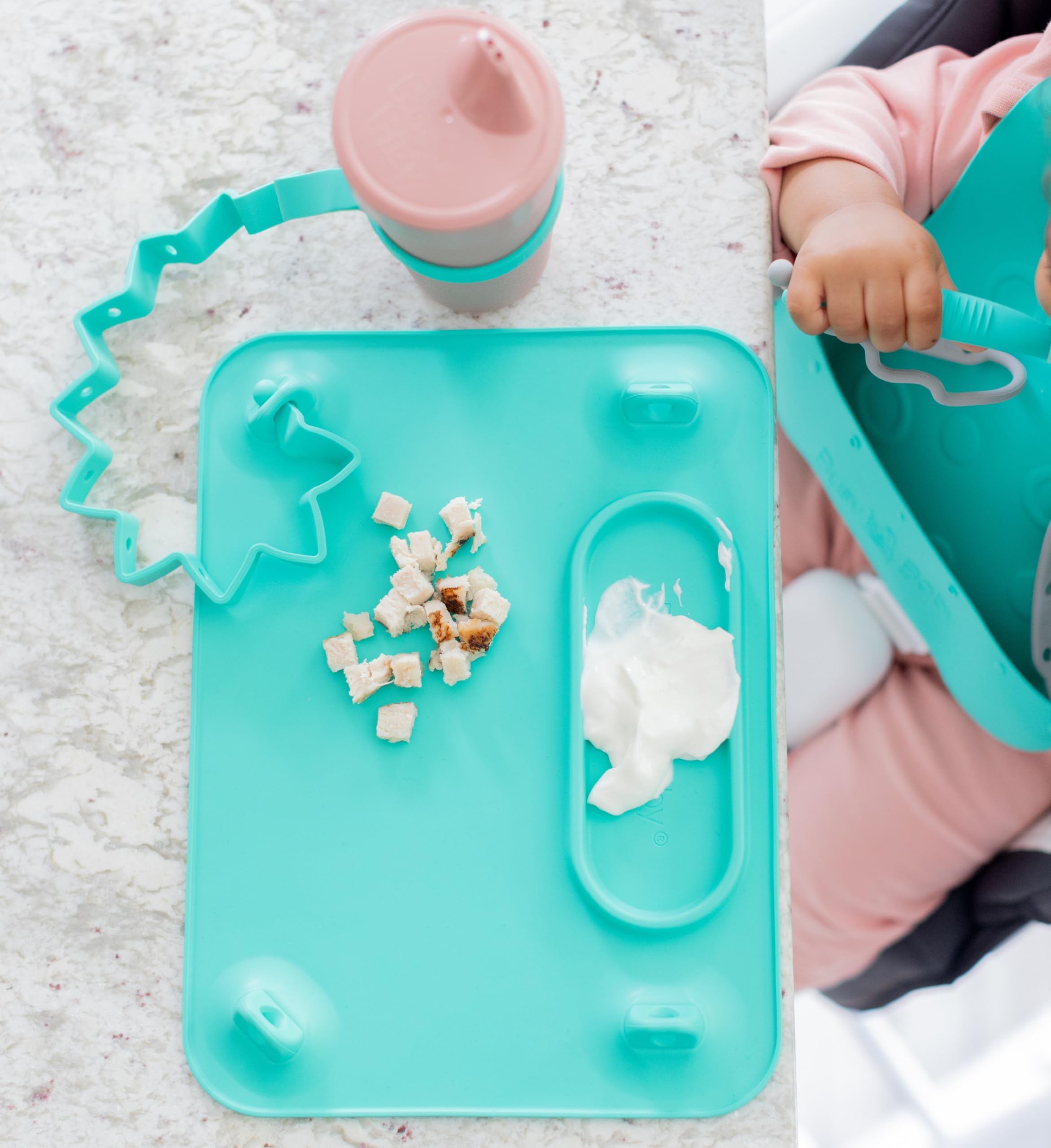 Busy Baby Bottle Bungee pink toddler-hands holding cup with strap during snack.
