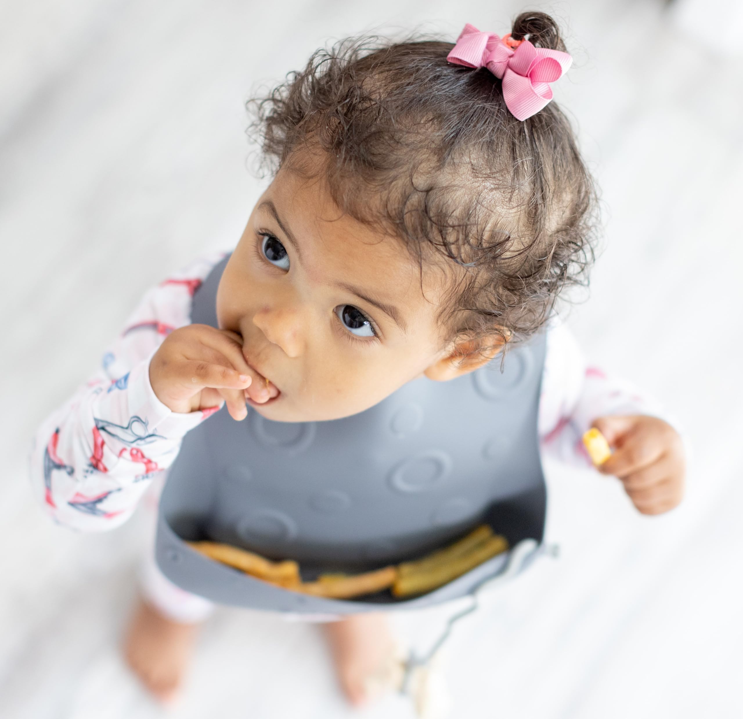 BUSY BABY Bungee Bib rolled storage shows portable, travel-ready design.
