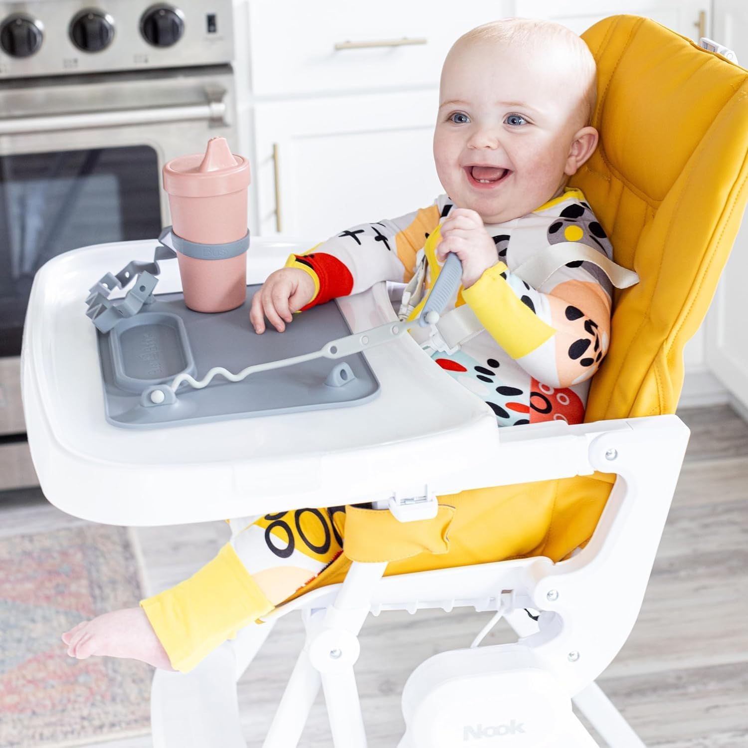 Busy Baby placemat attached to a smooth surface prevents spills during meals.