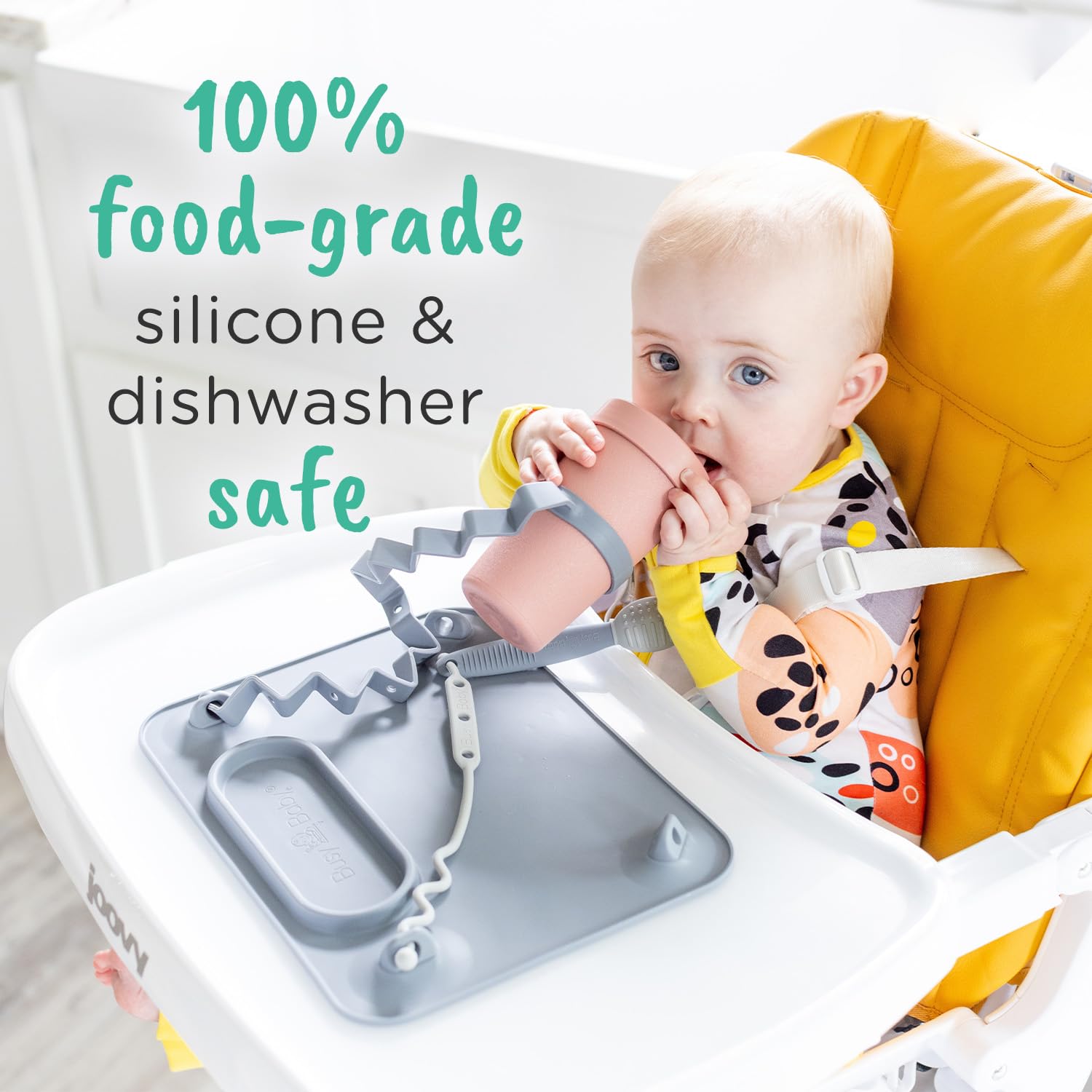 BUSY BABY Silicone Mat straps securing utensils and cups off the floor.