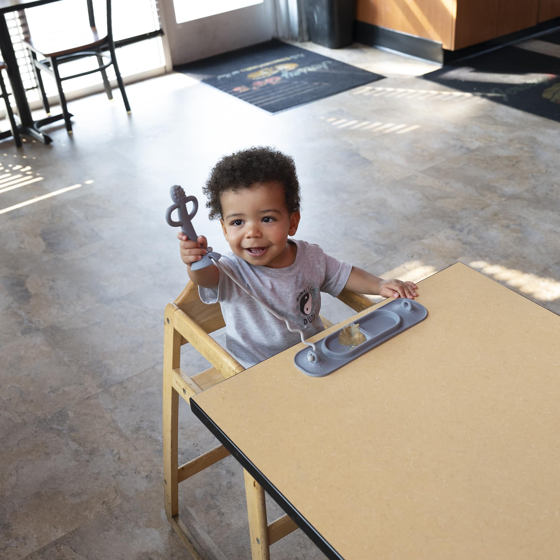 Busy Baby Silicone Mini Mat sticks to glass or fridge surfaces for stable use