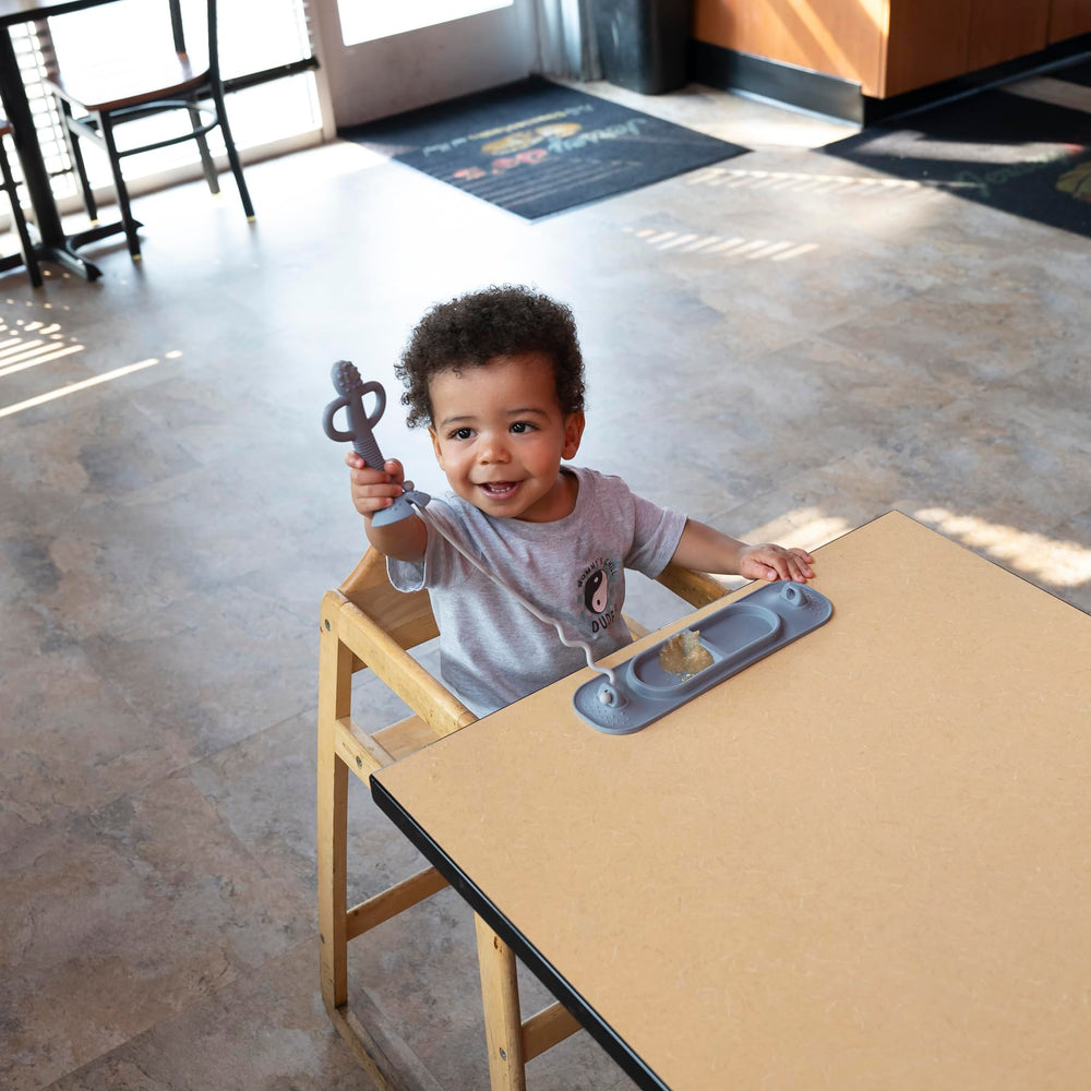 Busy Baby Silicone Mini Mat sticks to glass or fridge surfaces for stable use