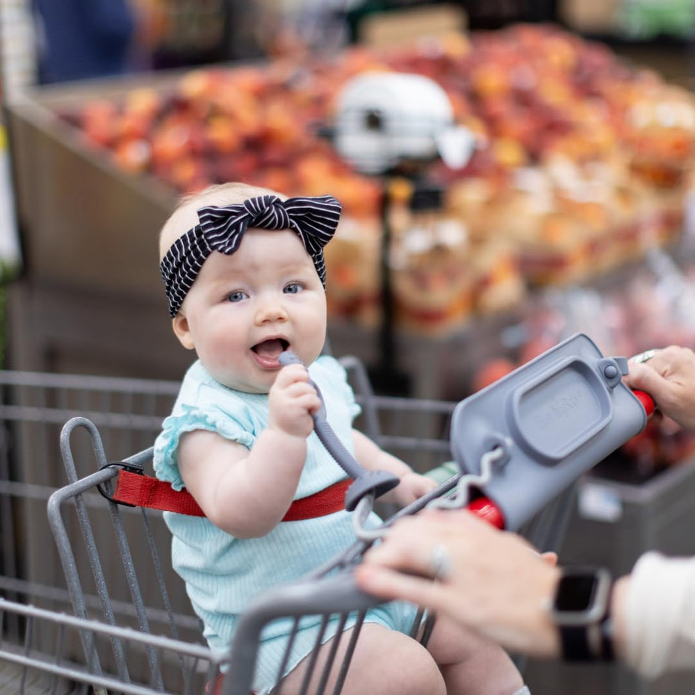 Busy Baby universal bungee straps securing bottles to a stroller for on-the-go convenience.