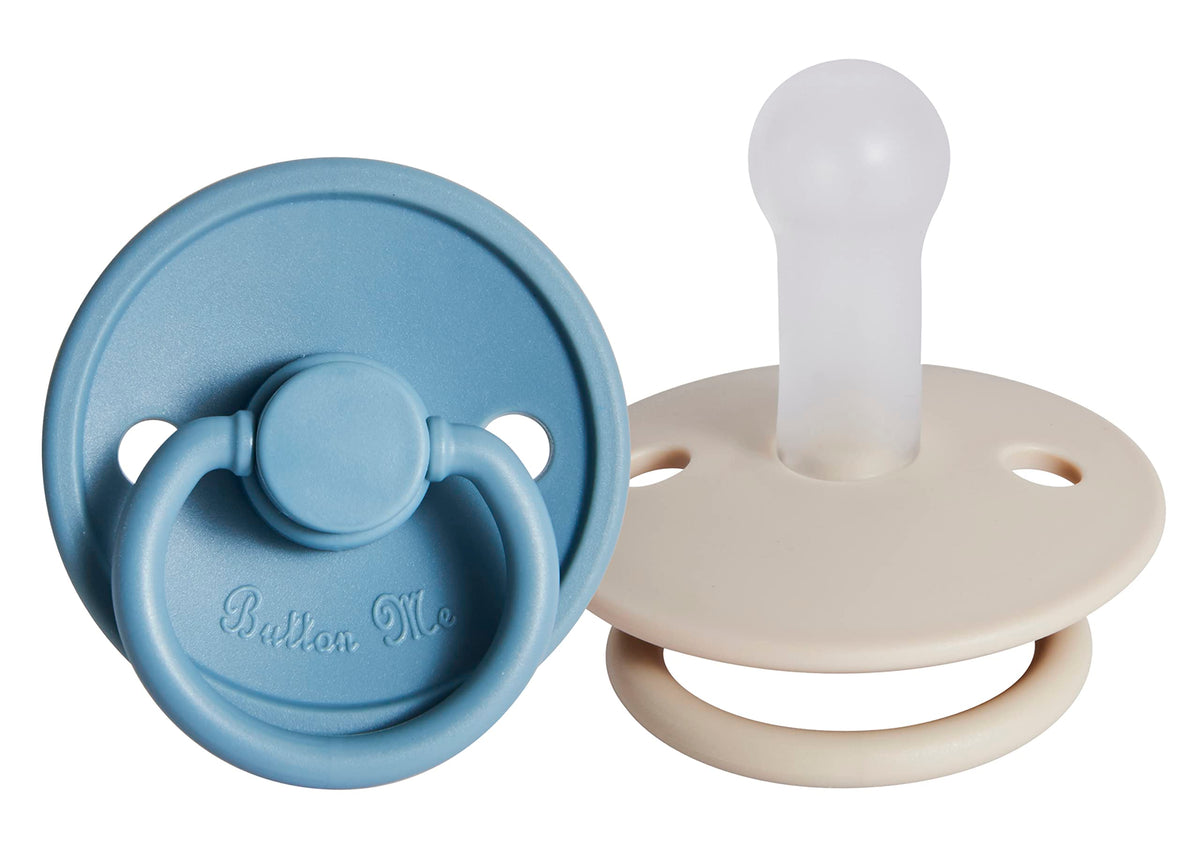 Button Me premium soft silicone pacifier 2-pack packaging demonstrates durable soothing design.