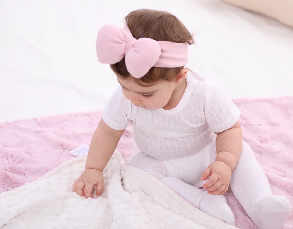 Buttzo baby blanket reversible design shows dual textures for versatile use.