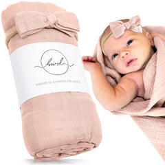 Baby Want Designs premium swaddle in dusty blush folded, highlighting ultra-soft material for newborn comfort.