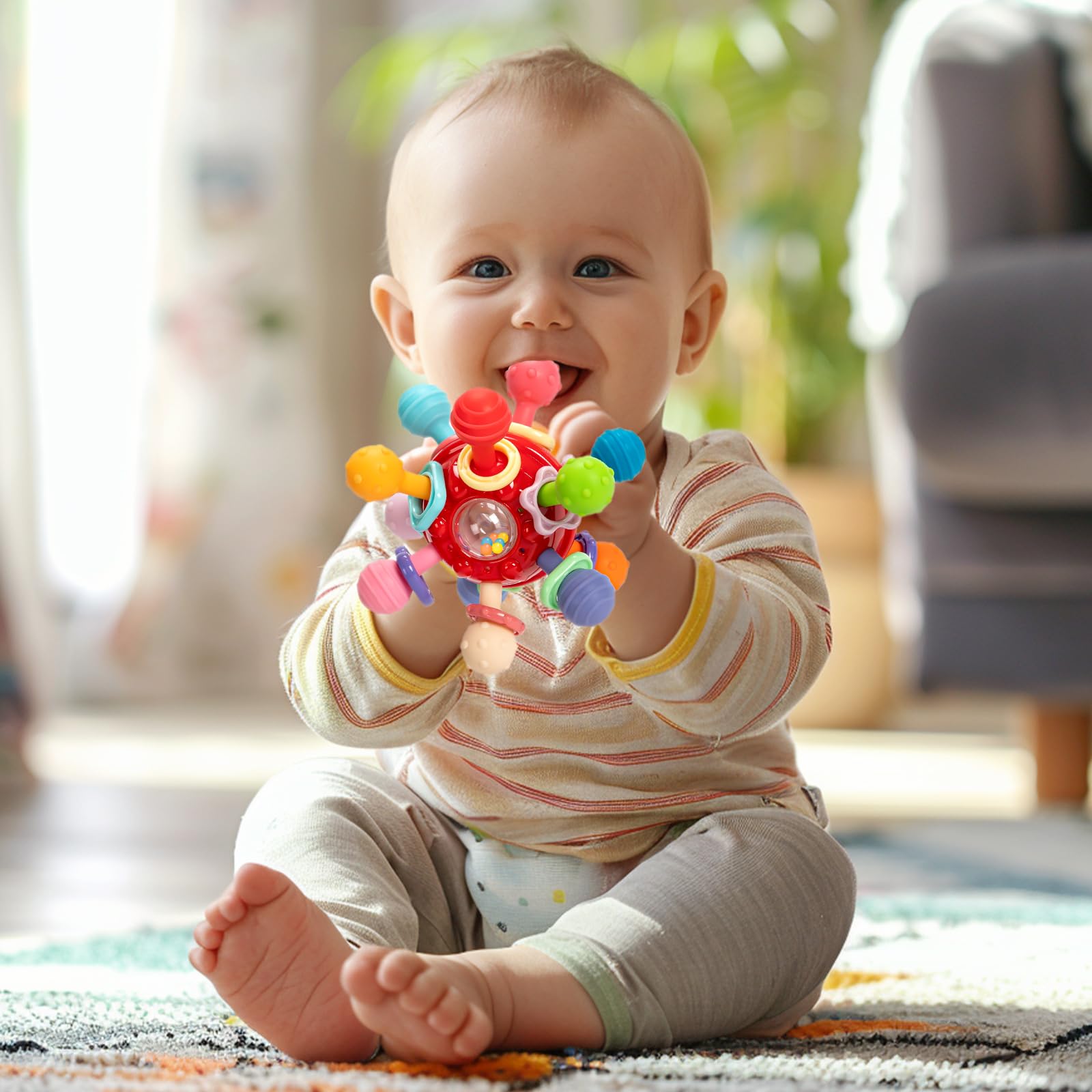 CAHILON teether features rattle ring and rotating balls for engaging play.