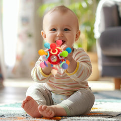 CAHILON teether features rattle ring and rotating balls for engaging play.