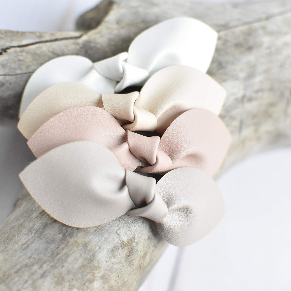 California Tot bow clip in hand demonstrates compact, lightweight design.