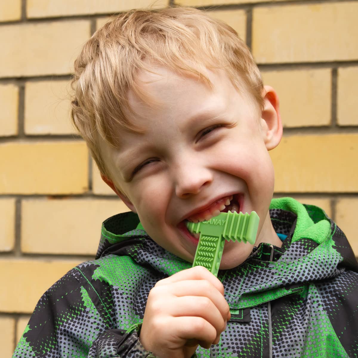 CANAY Xtra Tough Sensory Chew Bricks kid-holding action highlights durable design for aggressive chewers