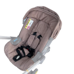 Canopy sunshade cover beige on Doona stroller protects baby from sun and breeze.