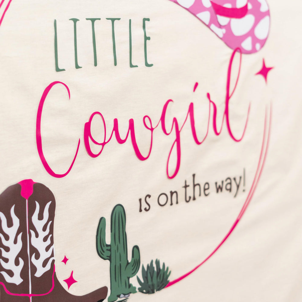 Capiont Cowgirl party decal serves as playful backdrop for photos.