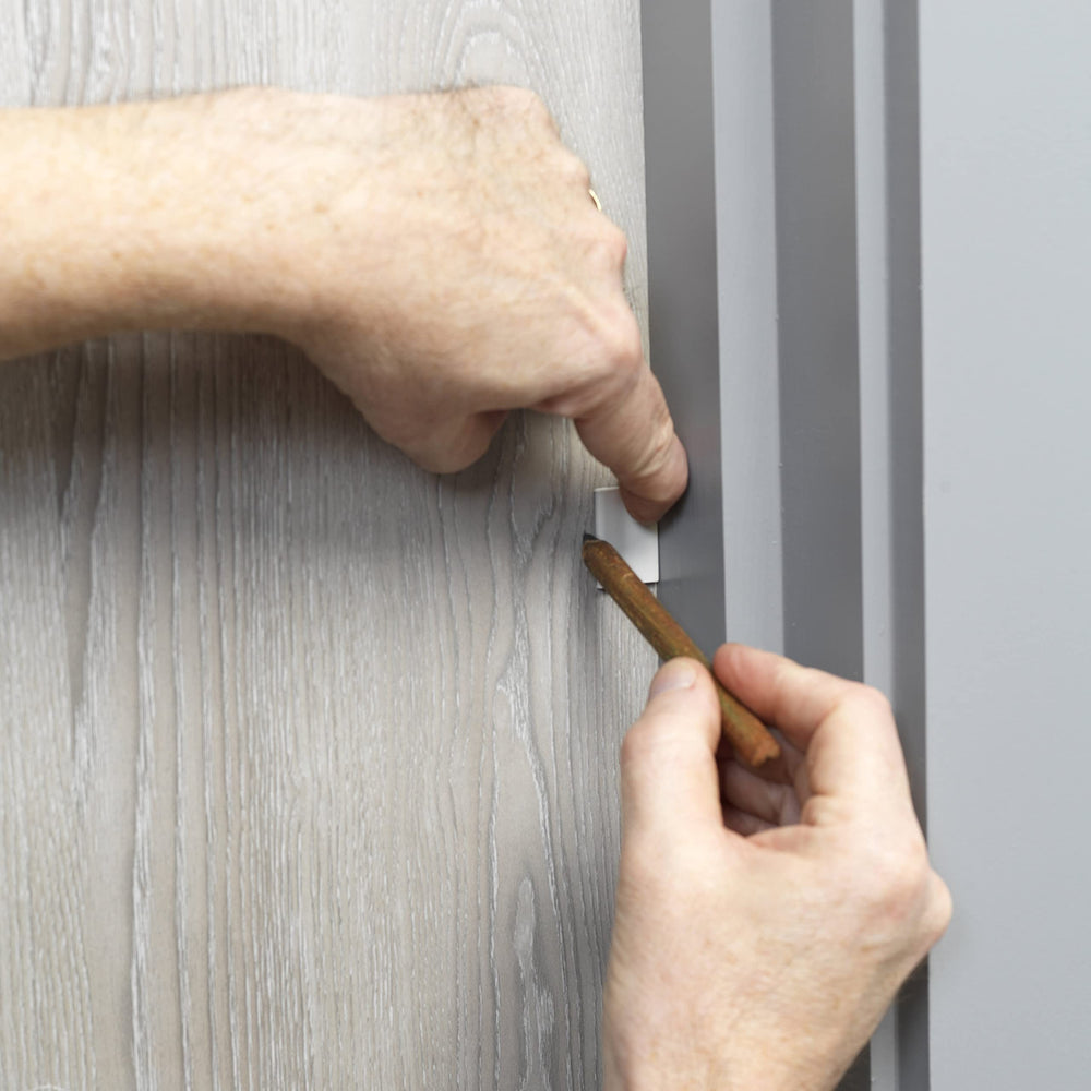 Cardea Solutions hinge protector bridges door and frame for safer door use