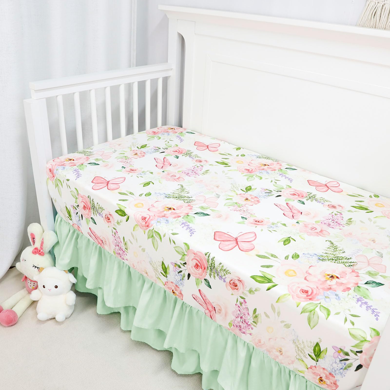 CARUILI ruffled crib skirt in green accents hides under-crib storage for a neat look.