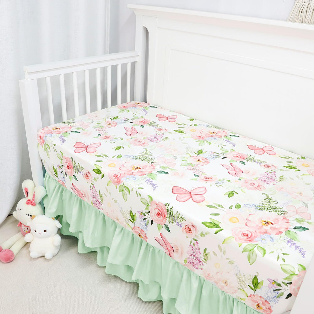 CARUILI ruffled crib skirt in green accents hides under-crib storage for a neat look.