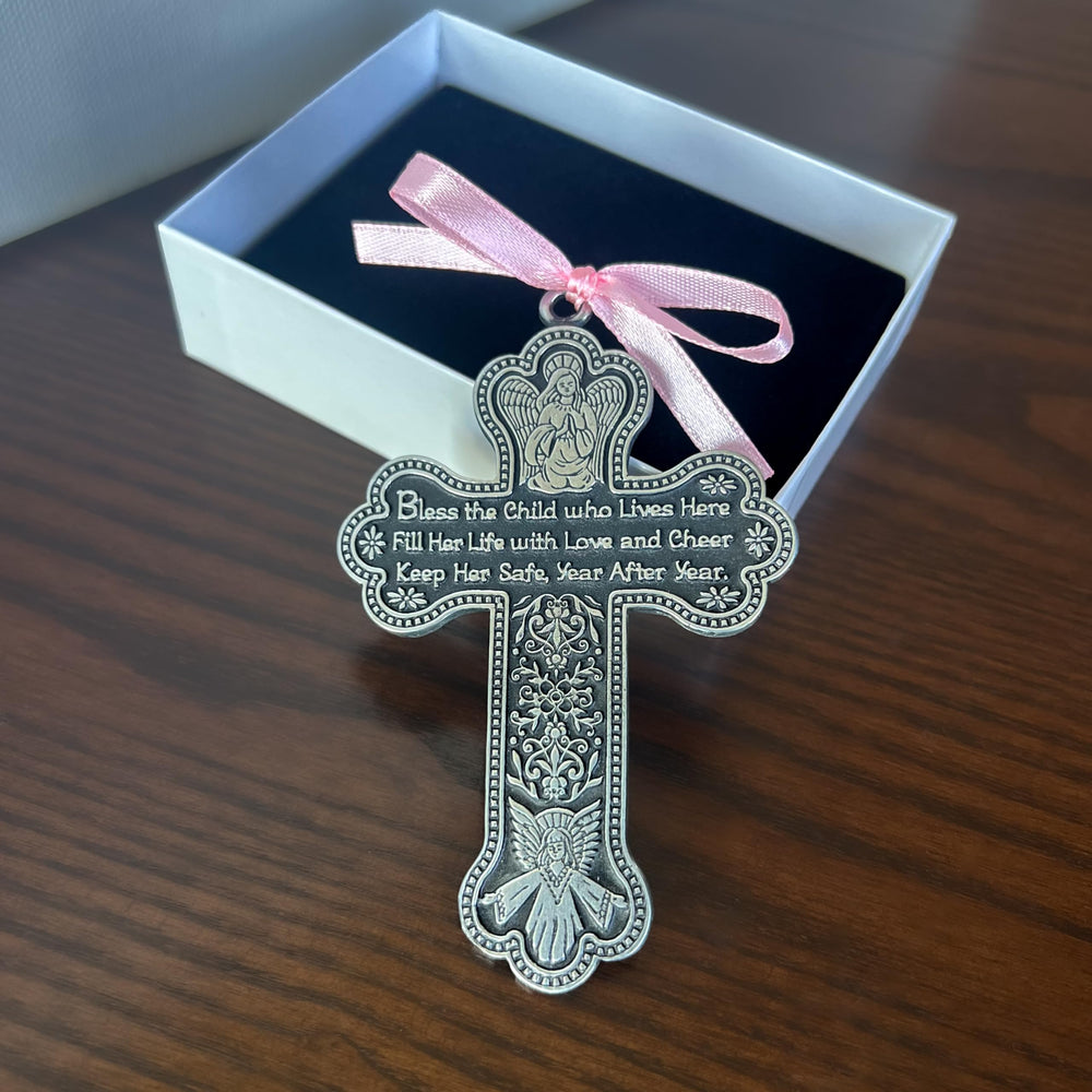 Cathedral Art CM7 cross crib medal displayed in nursery decor setting.