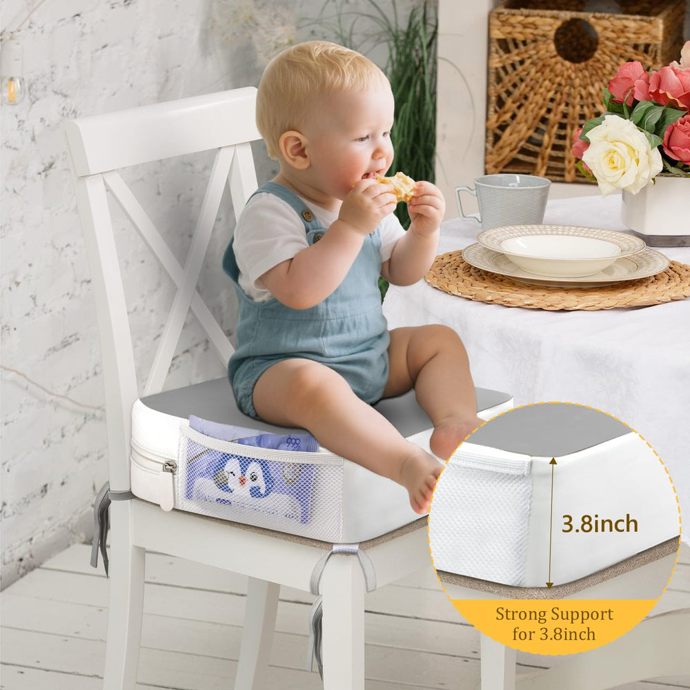 CAVWVTYU booster seat side pockets hold wipes and toys within reach.