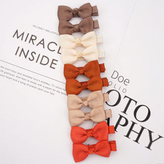CÉLLOT CLLOT fully lined clips with grosgrain ribbon for gentle wear.