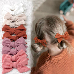 CÉLLOT linen-texture close-up of pink bows for soft touch.