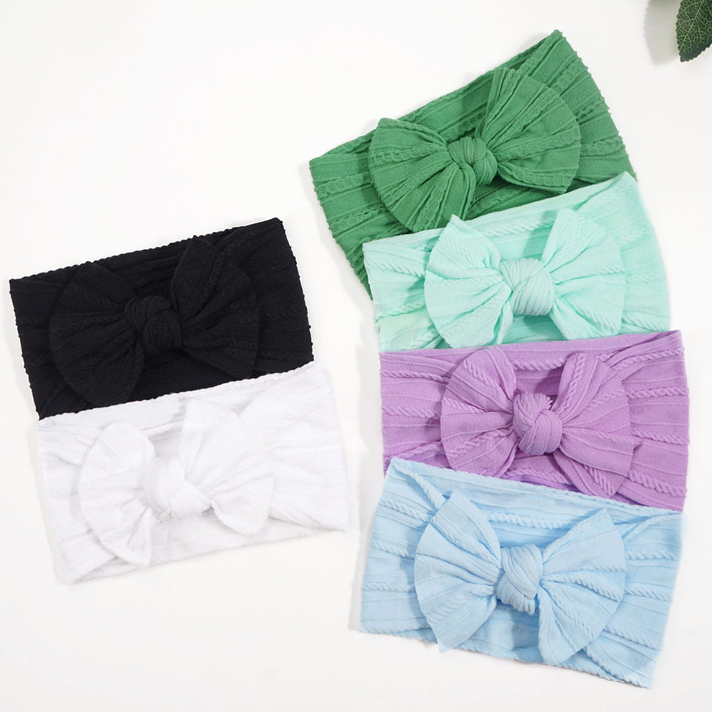 CÉLLOT elastic baby headband; breathable nylon and gentle fit.