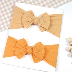 CÉLLOT red bow headband, bright accent for newborns and infants alike.