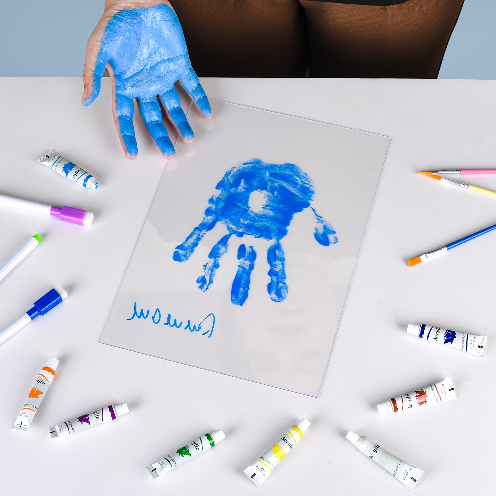 Cepairng clear acrylic sheets ready for two-handprint layouts.