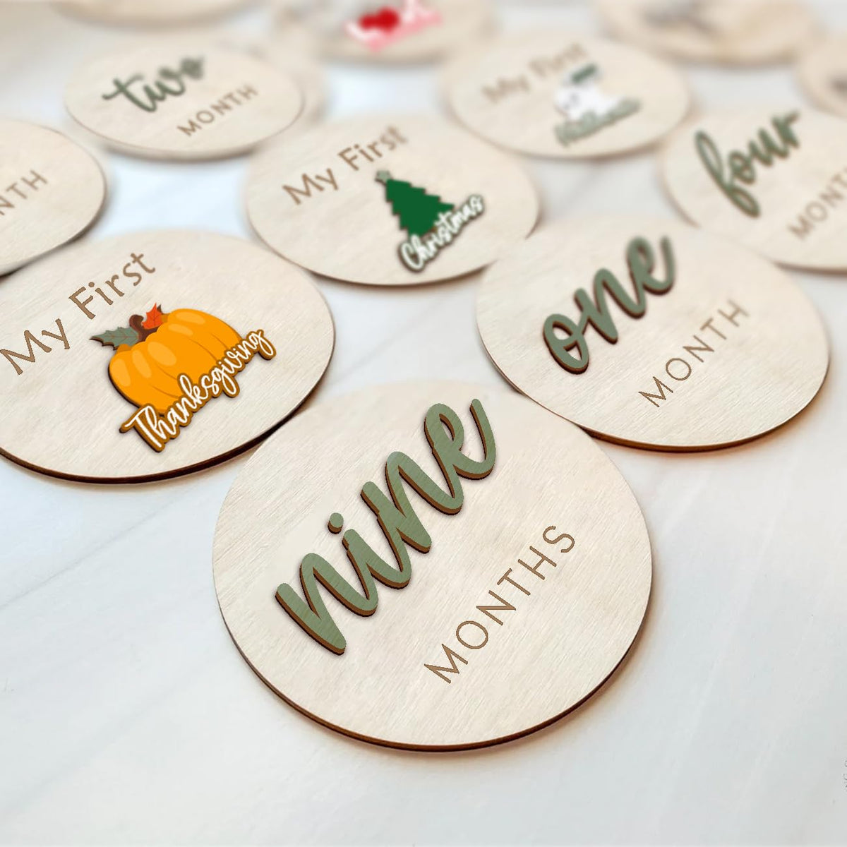 Cephira monthly milestone discs board tracks baby’s 1–12 months with removable stickers.