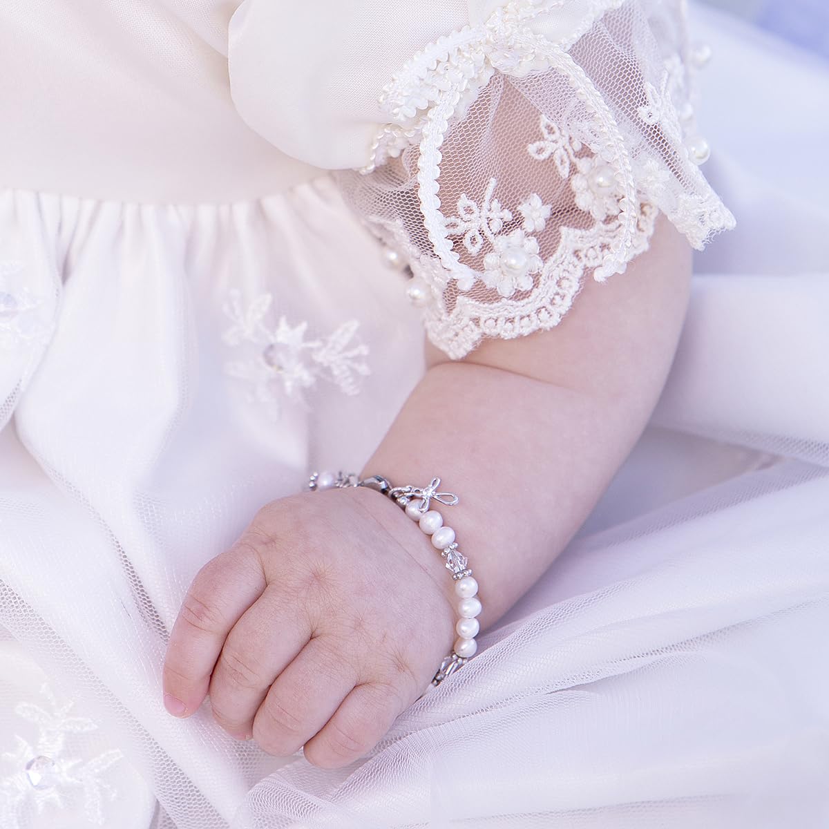 Cherished Moments Babe to Bride cross bracelet worn as baby signals sentimental future wedding ritual