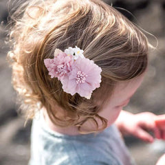 Cherrboll handmade flower clip close-up highlighting natural fabric petals and pearls.