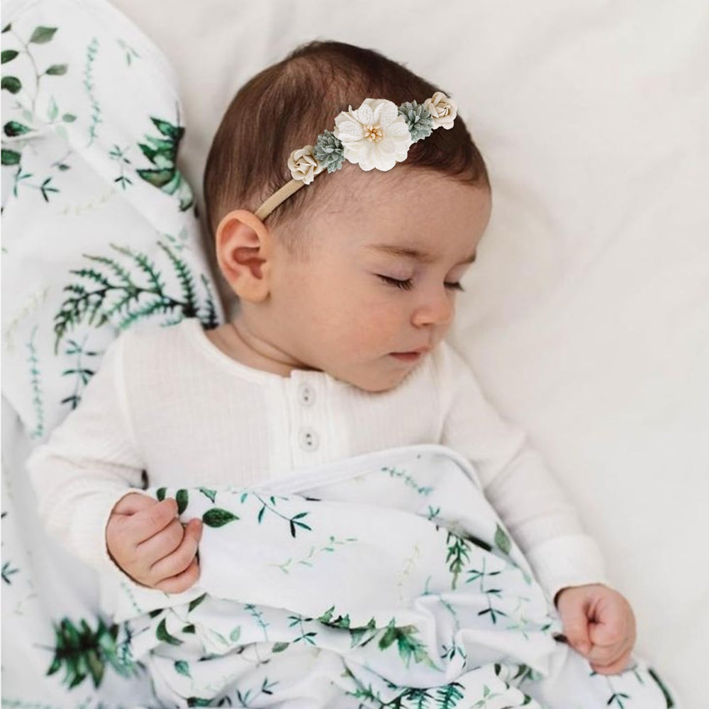 Cherrboll newborn headband shown on head demonstrates growth-friendly stretch