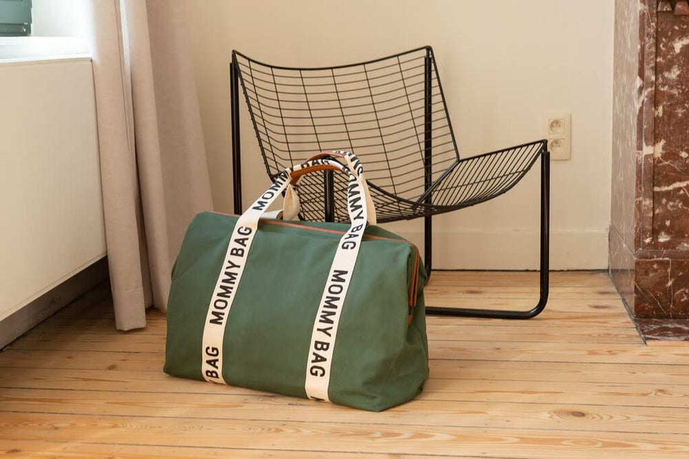 Childhome Signature Mommy Bag green changing mat for on-the-go comfort.